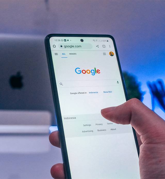 Hand-holding-phone-to-search-something-on-google-search